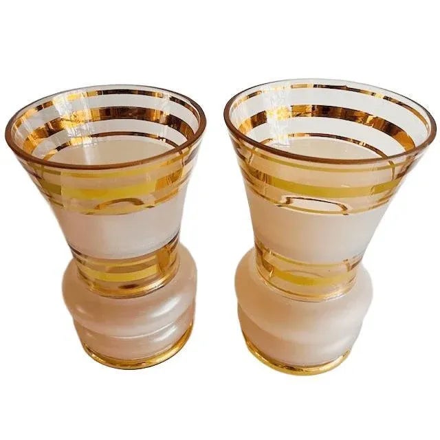 A pair of Hollywood Regency gilded pink glass vases from the De Rupel glassworks from the 1930s. The vases have a...