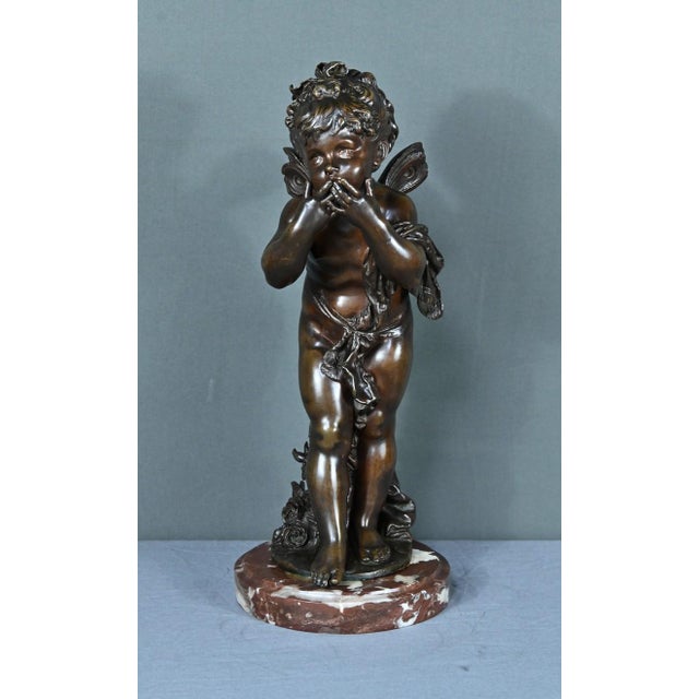 This bronze entitled “Love Sending Kisses” was sculpted by Auguste Moreau at the end of the 19th century. It depicts a...