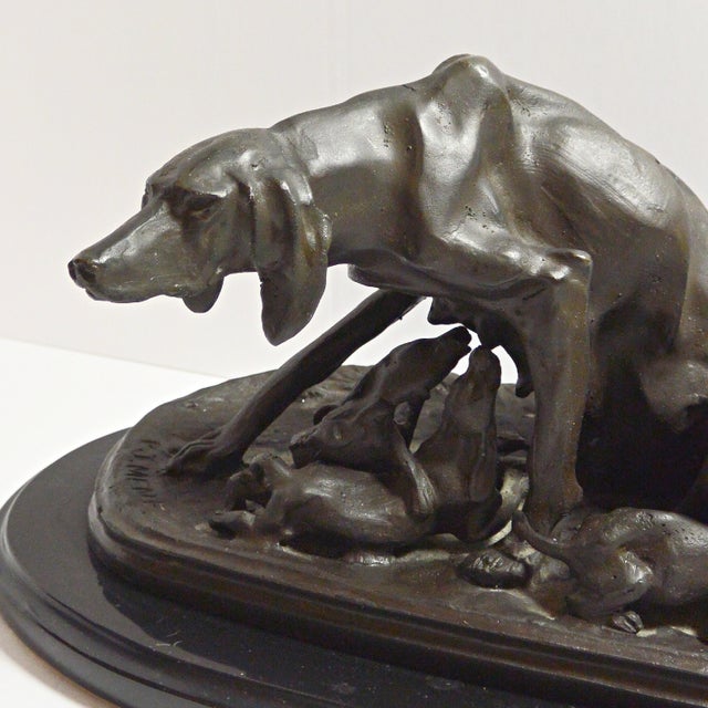 An exquisite example of 19th-century French Animalier art, this bronze sculpture entitled "Bitch with Pups" (Saintongeois...