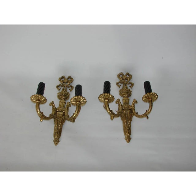 A pair of palace style wall lamps. The set is made entirely of brass, the cover on the frame is also brass varnished. They...