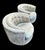 A pair of barrel-back swivel lounge chairs, circa 1970s, in the manner of Milo Baughman. Wraparound silhouette with low...