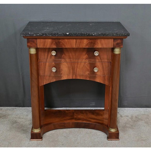 This small “all-sided” chiffonier chest of drawers in solid mahogany and burl mahogany veneer, opens at the waist with a...