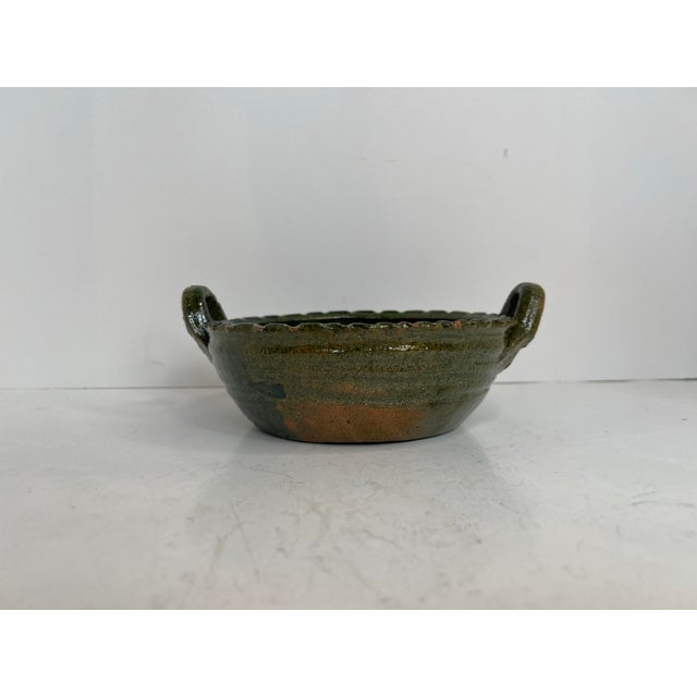 A beautifully rustic Oaxacan barro verde pottery serving bowl featuring rich variegated green glaze, hand-thrown...