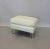 High style white leather ottoman on Lucite legs. Very well made. Leather shows patina more than age. Wrinkles in the...