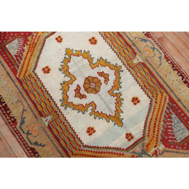 A colorful antique Turkish Ghiordes rug from the second quarter of the 20th century. Measures: 3'8'' x 5'5'' Since the...