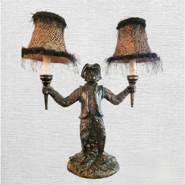 A fun whimsical double arm vintage monkey table lamp. The lamp has such wonderful character with a monkey all dressed in a...