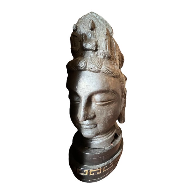 This extraordinary pair of "Heroic" scale cast iron heads represents a rare survival of monumental Buddhist temple...