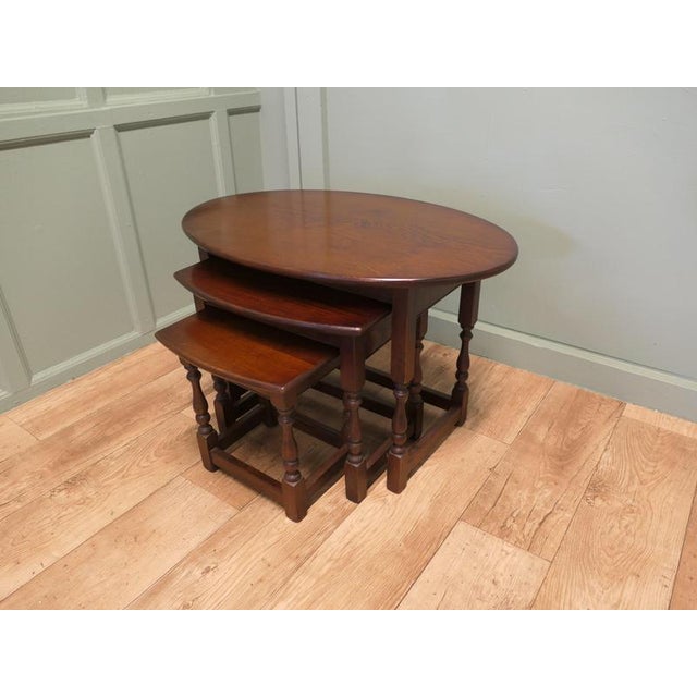 This is a very unusual set of tables, the largest table is oval in shape and the others give the appearance of being oval...