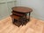 This is a very unusual set of tables, the largest table is oval in shape and the others give the appearance of being oval...