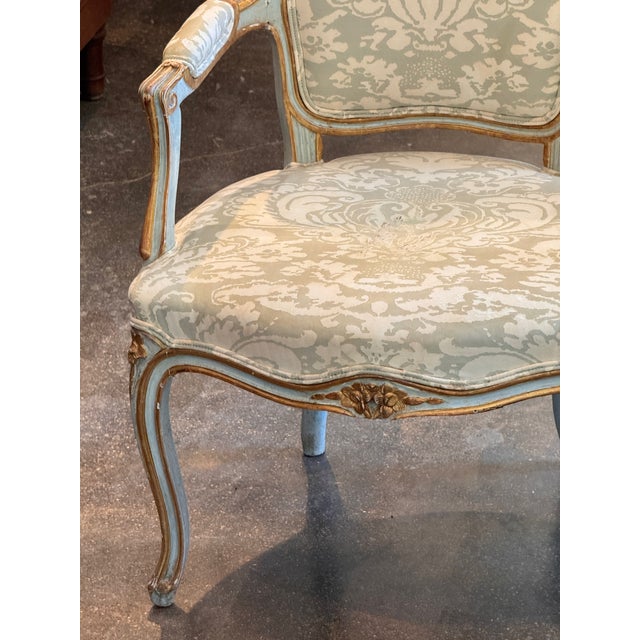 Pair of Italian armchairs with cartouche-shaped backs, the molded frames painted in pale blue-gray and parcel-gilt, carved...