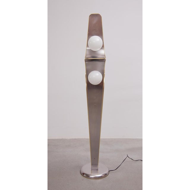 An exceptionally rare designer lamp designed in brushed metal in a wave shape with a brass edge and three opaline glass...