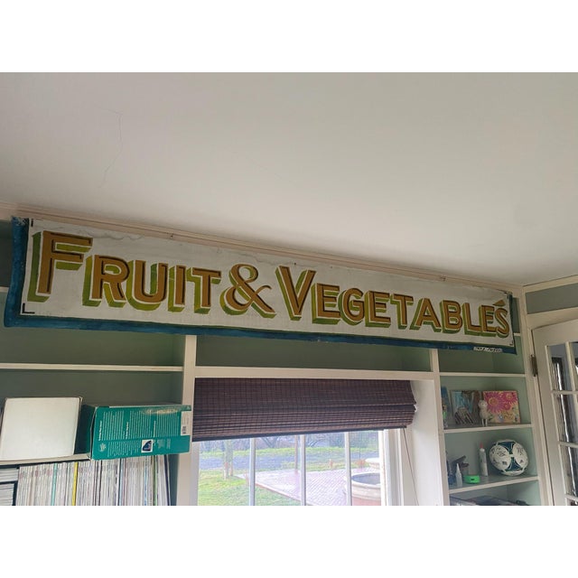 Canvas sign mounted on wood and hanging from eye hooks. Looks to be hand painted. Purchased at a local antique mall...