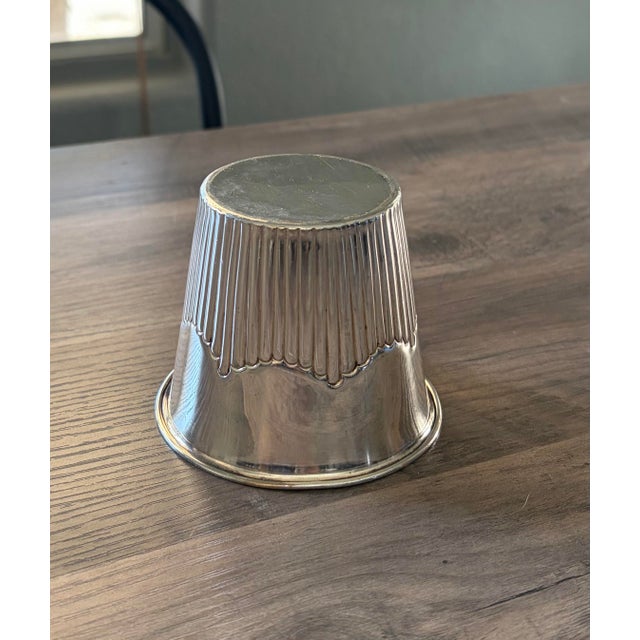 Add a touch of old-world charm to your collection with this beautifully aged silver-plated cup, featuring an elegant...