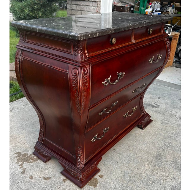 A Bombay® Furniture Co. Marble Top Bombe Chest in a Classic French