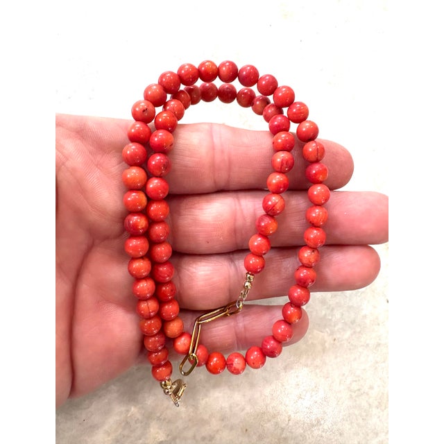 Lovely coral beaded necklace with gold tone clasp.