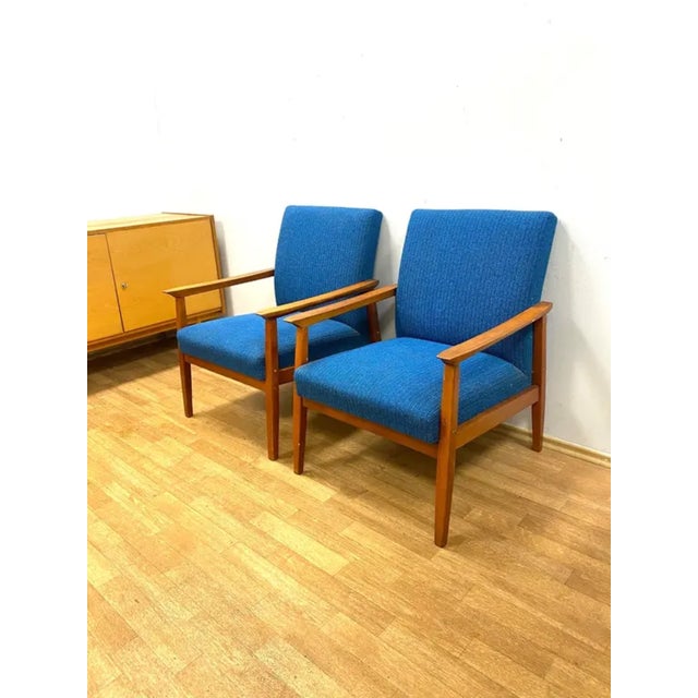 This pair of retro armchairs was made in the Czechoslovak Republic in the 1960s by TON, featuring a wooden frame with...