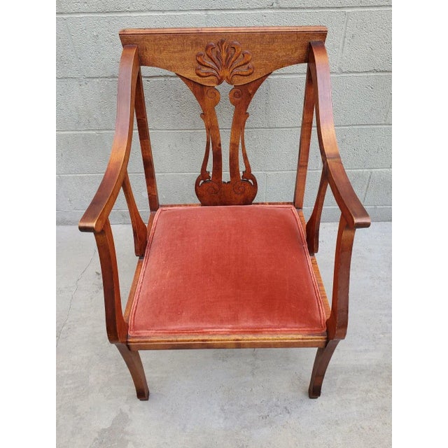 Wooden chair with unusually tall arms that are the perfect height for holding any reading material. Very comfortable....