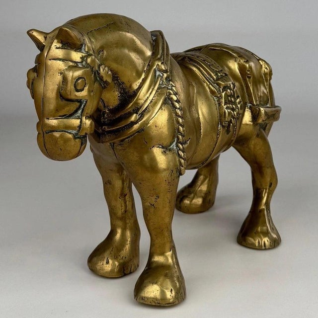 A substantial and characterful 19th-century brass sculpture depicting a powerful Shire horse, finely modelled with...