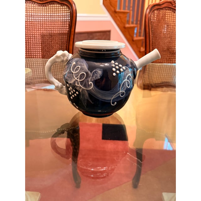 A striking and uniquely expressive vintage studio art pottery teapot featuring a bold, high-contrast design. The spherical...