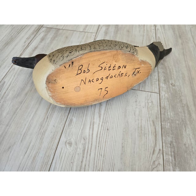 Elevate your folk art or sporting collection with this exceptional, hand-carved wooden duck decoy by celebrated East Texas...