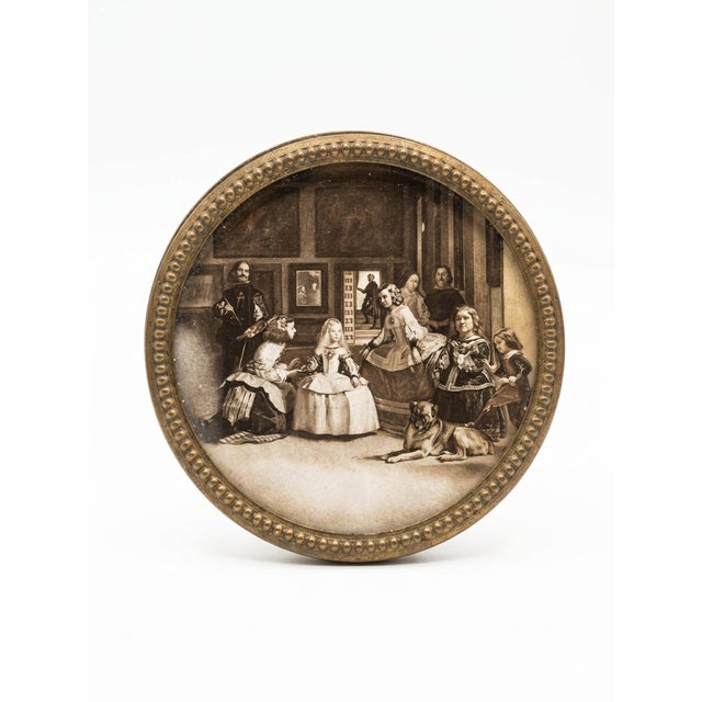 A distinctive vintage Spanish wall plaque featuring a finely detailed figural scene, set within a warm, carved wood frame...