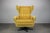 A mid-century swivel lounge chair manufactured in Czechoslovakia in the 1960s. This wingback armchair features a high...