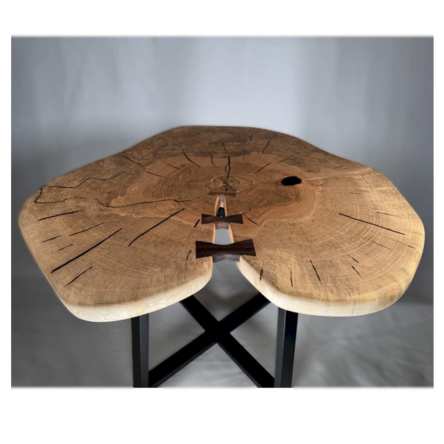 Hand-shaped from a single slab of locally sourced Black Walnut, this sculptural coffee table takes its organic silhouette...