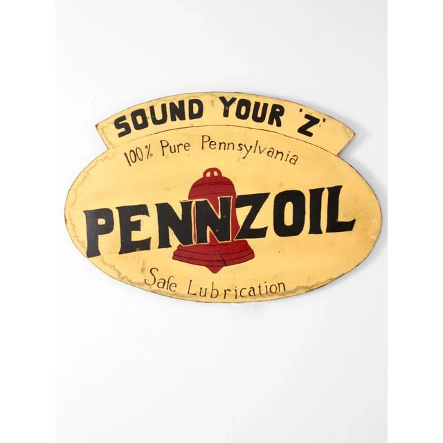 A striking vintage Pennzoil “Sound the Z” sign, hand-painted on presswood in a bold palette of signature yellow, black,...