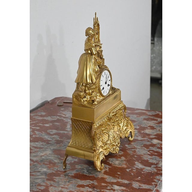 Finely chiseled golden bronze pendulum, decorated with a young pious woman in contemplation. The elegant young lady is...