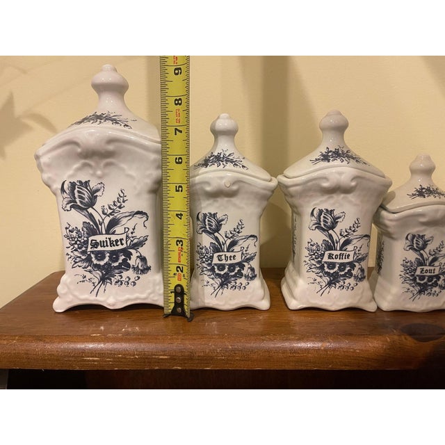A charming and exceptionally decorative 11-piece vintage T. Delfts Bleau graduated kitchen canister collection, dating to...