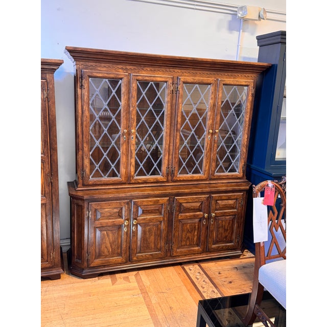 Design Plus Gallery presents an English Tudor Style Oak Wood Cabinet from Century Furniture. A molded crown with dentil...