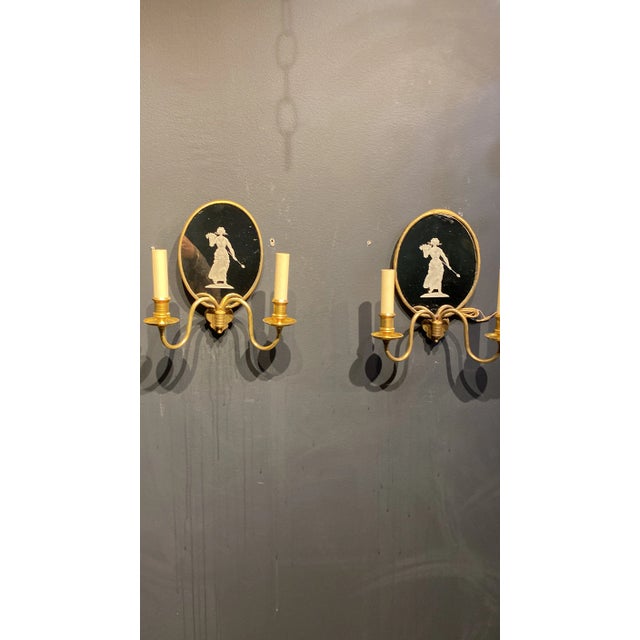 A pair of circa 1920’s Caldwell gilt bronze and etched mirror sconces. Neoclassic style