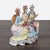 This beautiful Capodimonte sculpture features three finely dressed figures in classical attire playing music together....