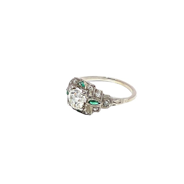Discover the timeless elegance of our Art Deco Diamond and Emerald Ring, a stunning piece crafted in luxurious platinum....