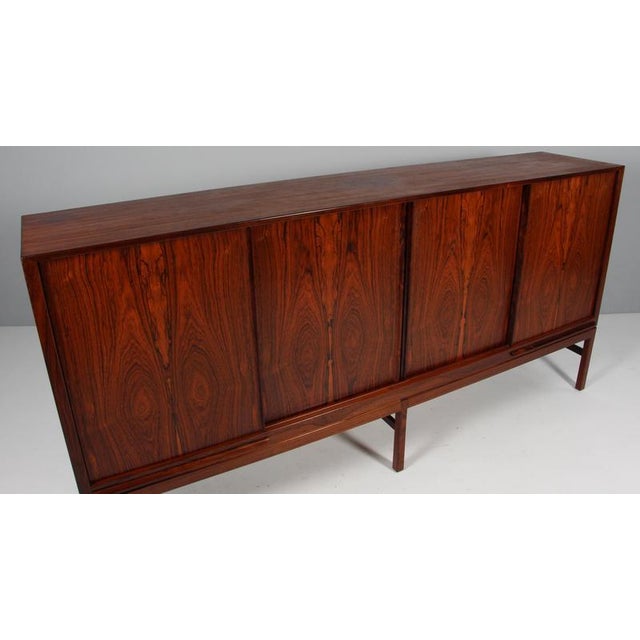 Kurt Østervig side table with shelves and drawers behind the doors. Made by K. P. Møbler. This piece is attributed to the...