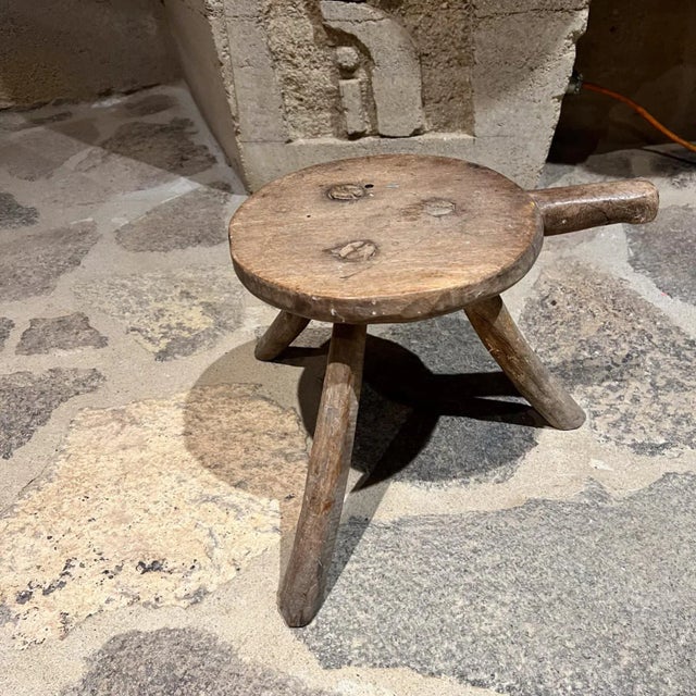 AMBIANIC presents early 1900s French milking stool. rustic mesquite wood. style of Pierre Jeanneret Firm and sturdy....