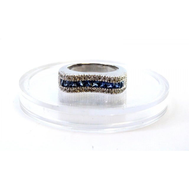 Gold ring with brilliant-cut diamonds, central band in cut blue topazes. Origin: Portuguese. Brand: Cabeça de eagle....