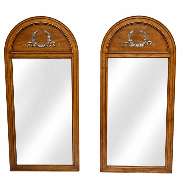 This Pair of Vintage Henredon Arched Wall Mirrors have a classically inspired presence and decorative metal ornamentation...