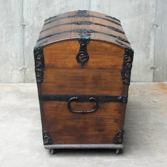 This large domed 18th Century Baroque Chest is made with solid oak and mounted with decorative iron strapwork and handles....