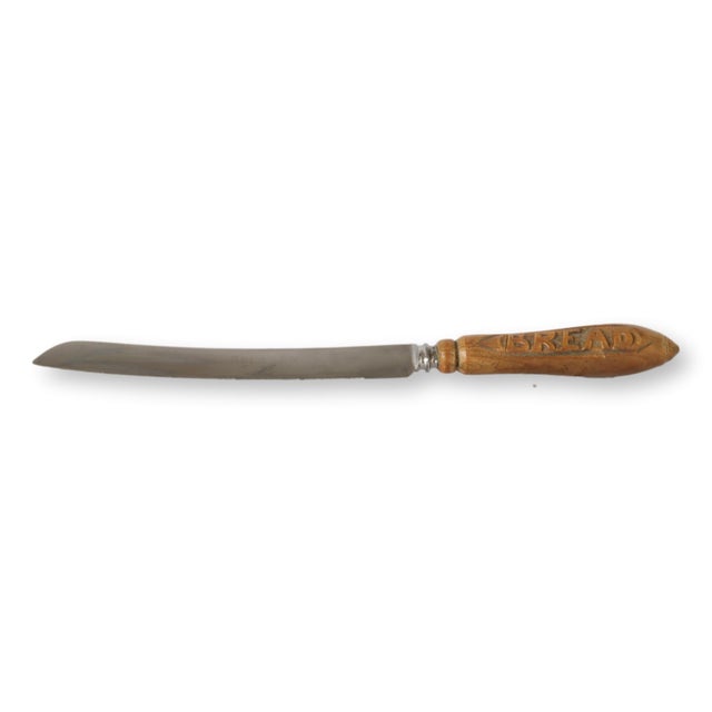 This charming antique English bread board, paired with a matching bread knife, offers a rustic yet practical addition to...