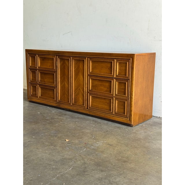 Crafted from high-quality oak wood, this dresser showcases a rich, warm finish with beautiful natural grain patterns. The...