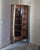 This is a vintage or antique American oak corner curio cabinet, likely dating from the early 20th century. Key Visual...