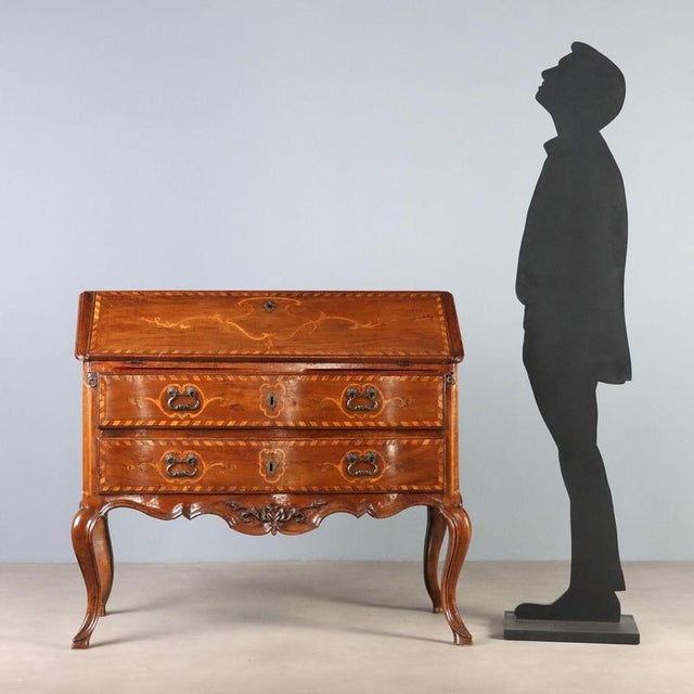 Baroque walnut bureau from Piedmont, second half of the 18th century, featuring a refined play of maple inlays. The...