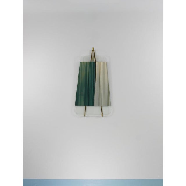 A rare Mid-Century modernist wall mirror from the 1950s, designed and manufactured by Carl Auböck in Vienna, Austria. The...