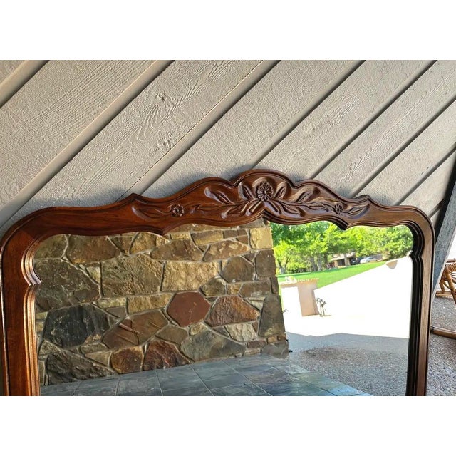 Vintage Drexel Cabinet Classics mirror featuring a carved wood frame in a warm walnut finish. Original vintage finish with...