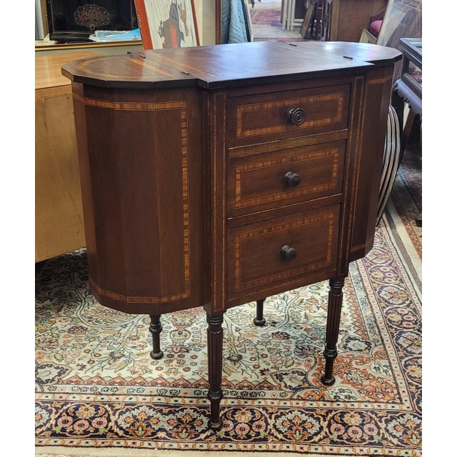 Fine antique sewing stand or entrance table. Features fine band inlay all around, two deep side compartments, three...