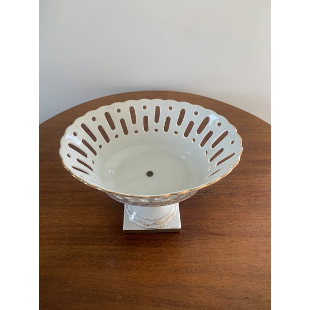 A refined reticulated porcelain basket, executed in a neoclassical idiom with delicate openwork and restrained gilt...
