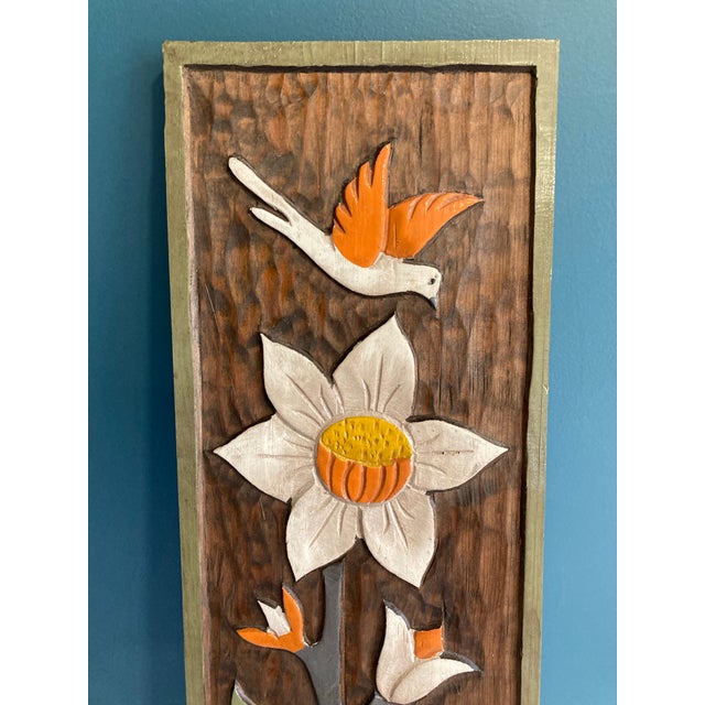 This vintage folk art wood wall panel showcases a beautifully hand-carved floral composition accented by a bird in flight....