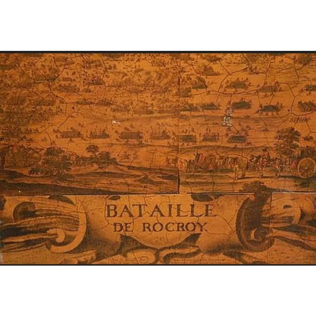 A striking vintage French three-panel folding screen dating to approximately the 1920s, featuring a large historic battle...