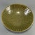 This bowl features distinctive radiating rib‑carved details both inside and out, covered with rich olive‑green celadon...